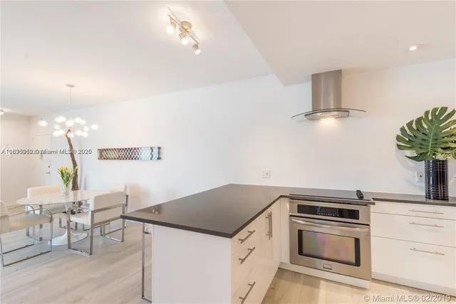 a kitchen with granite countertop a white cabinets and appliances