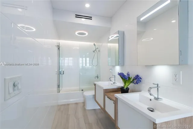 a bathroom with a sink a shower and a mirror