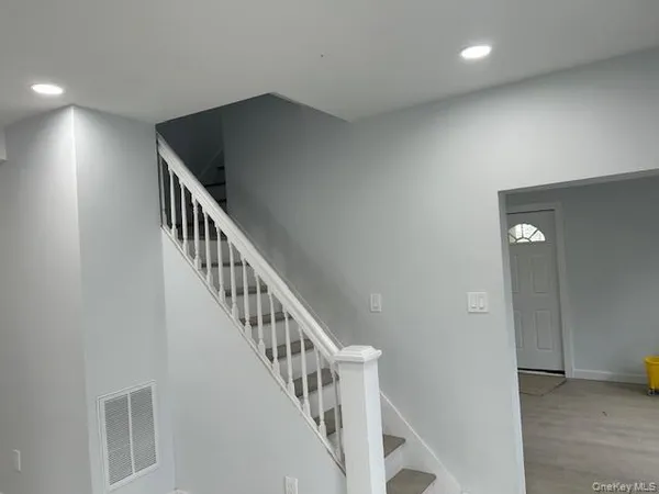 an entryway in a hall with a window