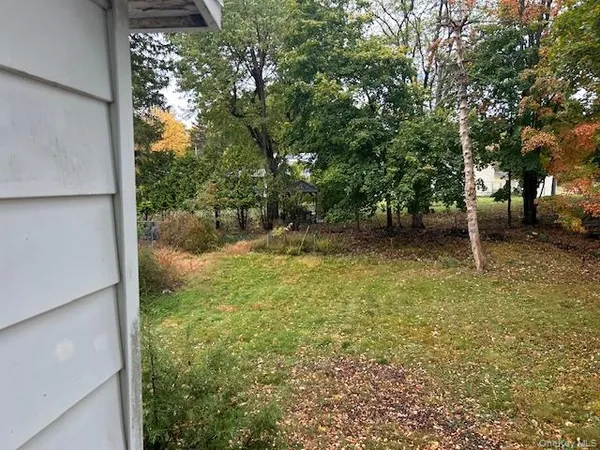 a view of a backyard with a tree