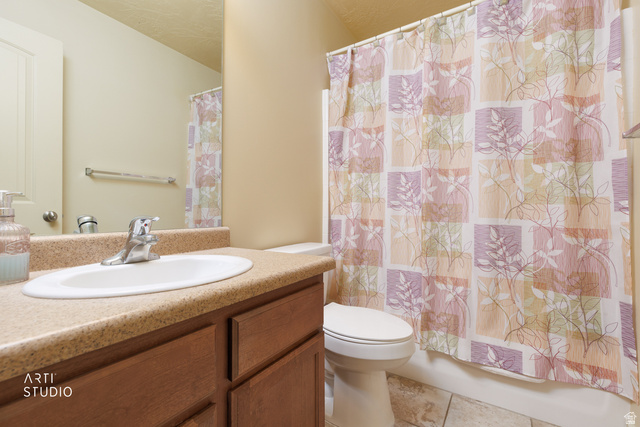 6761 950 East Midvale, UT 84047 - Photo 24 of 44 Bathroom featuring a wood-finish vanity with an integrated sink and a speckled countertop