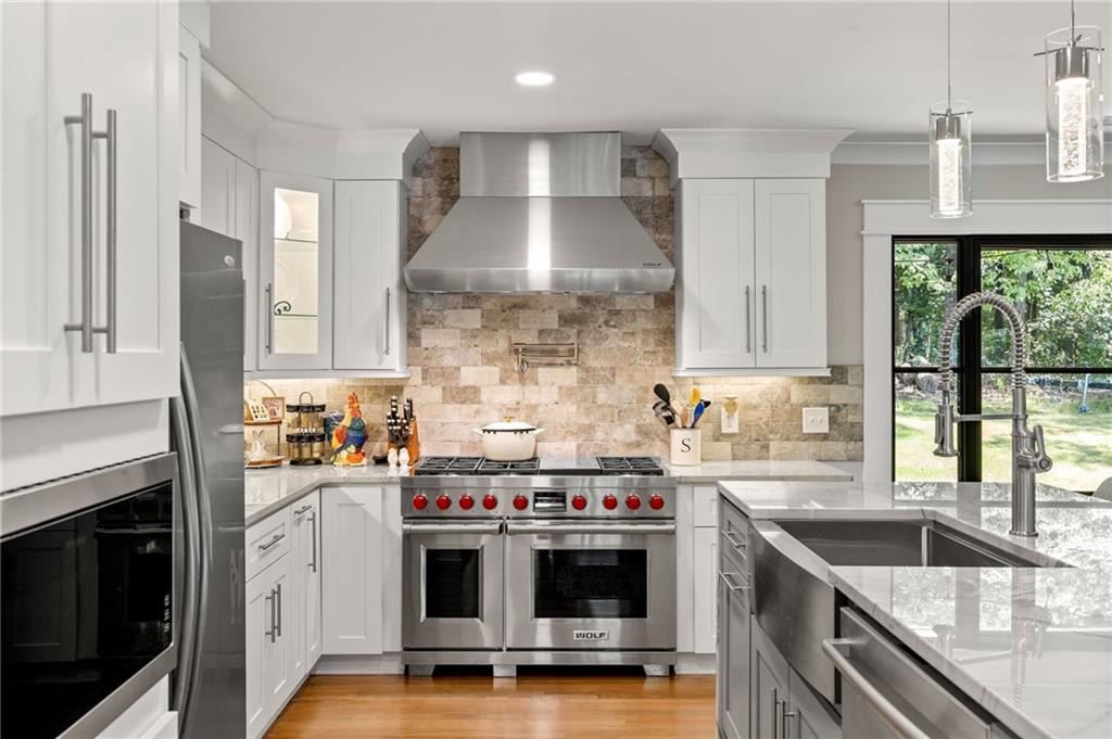 6470 Samoa Way Flowery Branch, GA 30542 - Photo 21 of 61 a kitchen with stainless steel appliances a sink a stove and a refrigerator