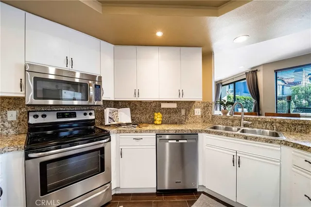 a kitchen with a sink stove and microwave