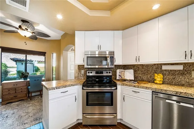 a kitchen with granite countertop a stove and a sink