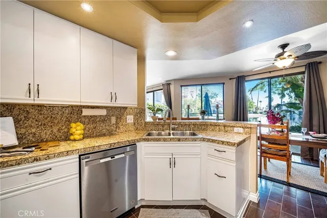 a kitchen with a sink window and cabinets