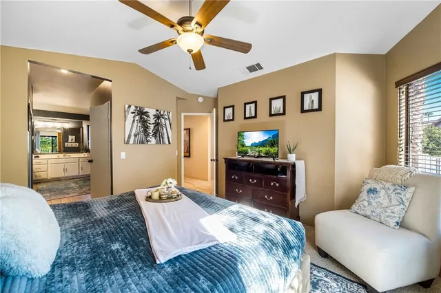 a bed sitting in a bedroom next to a window