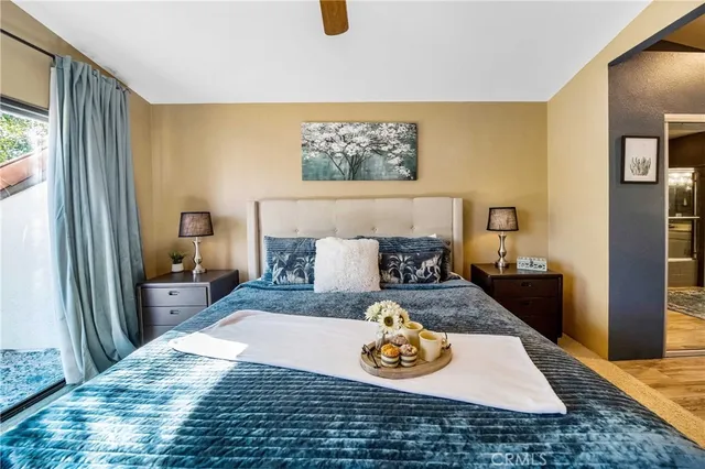 a bedroom with a bed and a potted plant