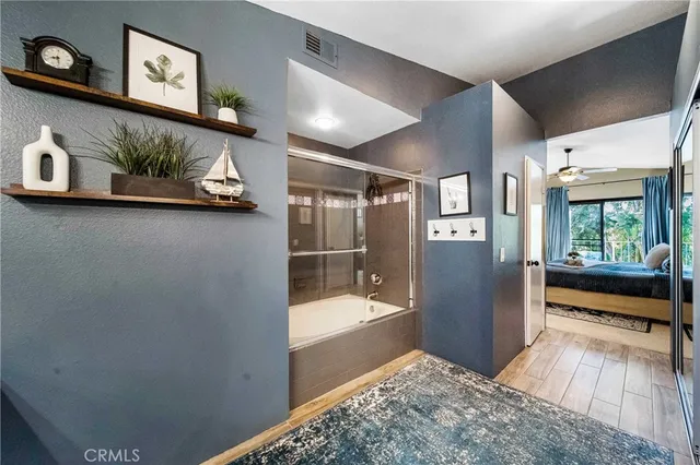 a bathroom with a large tub and shower