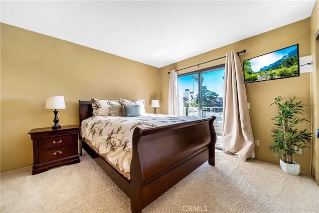 a view of a hallway with a livingroom and a bathroom