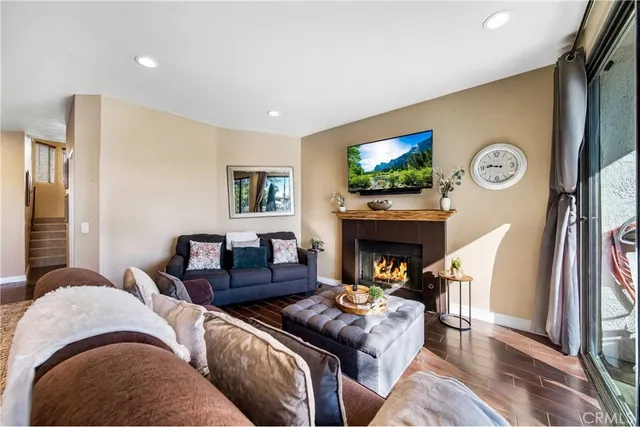 a living room with furniture a fireplace and a flat screen tv
