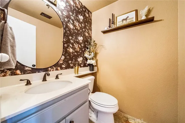 a view of a backyard with swimming pool and sitting area