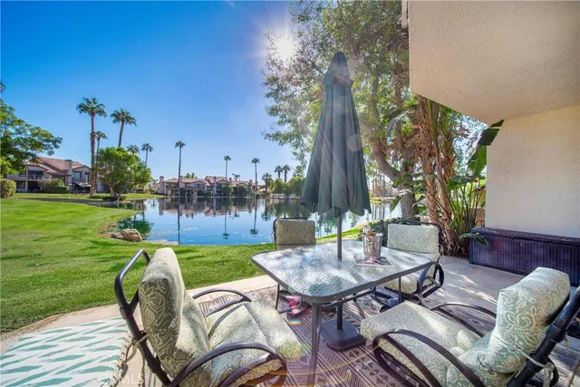 a view of a patio with table and chairs and potted plants