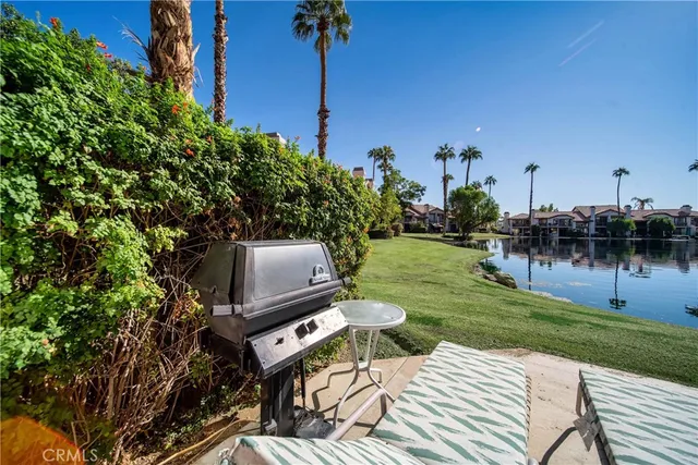 a front view of a house with a yard table and chairs