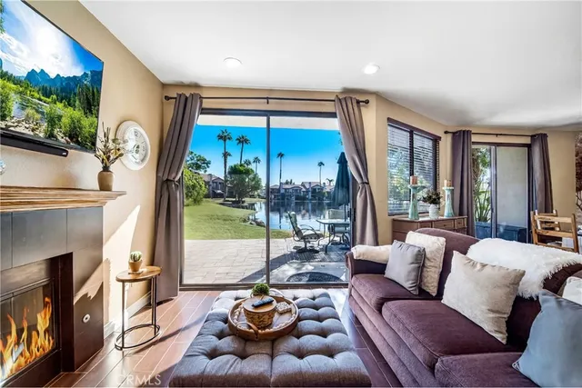 a living room with furniture fireplace and a large window