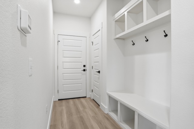 17 Wilson Loop Durant, OK 74701 - Photo 6 of 6 Built-in mudroom bench with storage cubbies and upper shelving, featuring black coat hooks