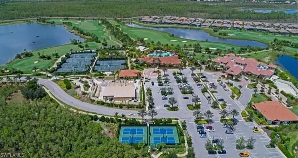 an aerial view of a house with a garden and lake view