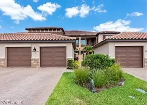 a view of a house with a yard and garage
