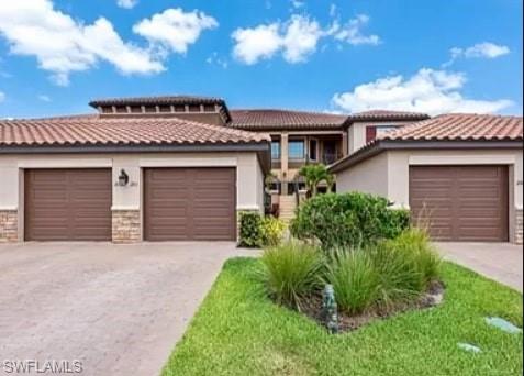 9397 Pocida Court, Unit 203 Naples, FL 34119 - Photo 16 of 32 a view of a house with a yard and garage