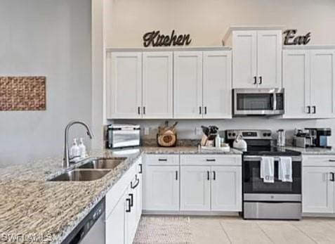 9397 Pocida Court, Unit 203 Naples, FL 34119 - Photo 22 of 32 a kitchen with stainless steel appliances granite countertop a sink stove and cabinets