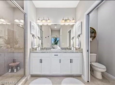 9397 Pocida Court, Unit 203 Naples, FL 34119 - Photo 29 of 32 a bathroom with a granite countertop sink toilet a mirror and shower