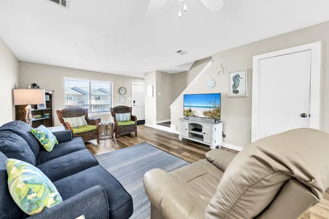 a dining room with furniture wooden floor and a rug