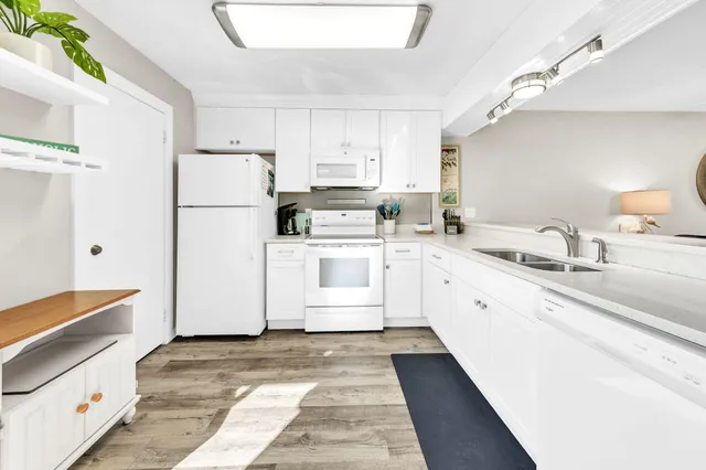 a kitchen with white cabinets sink and white appliances
