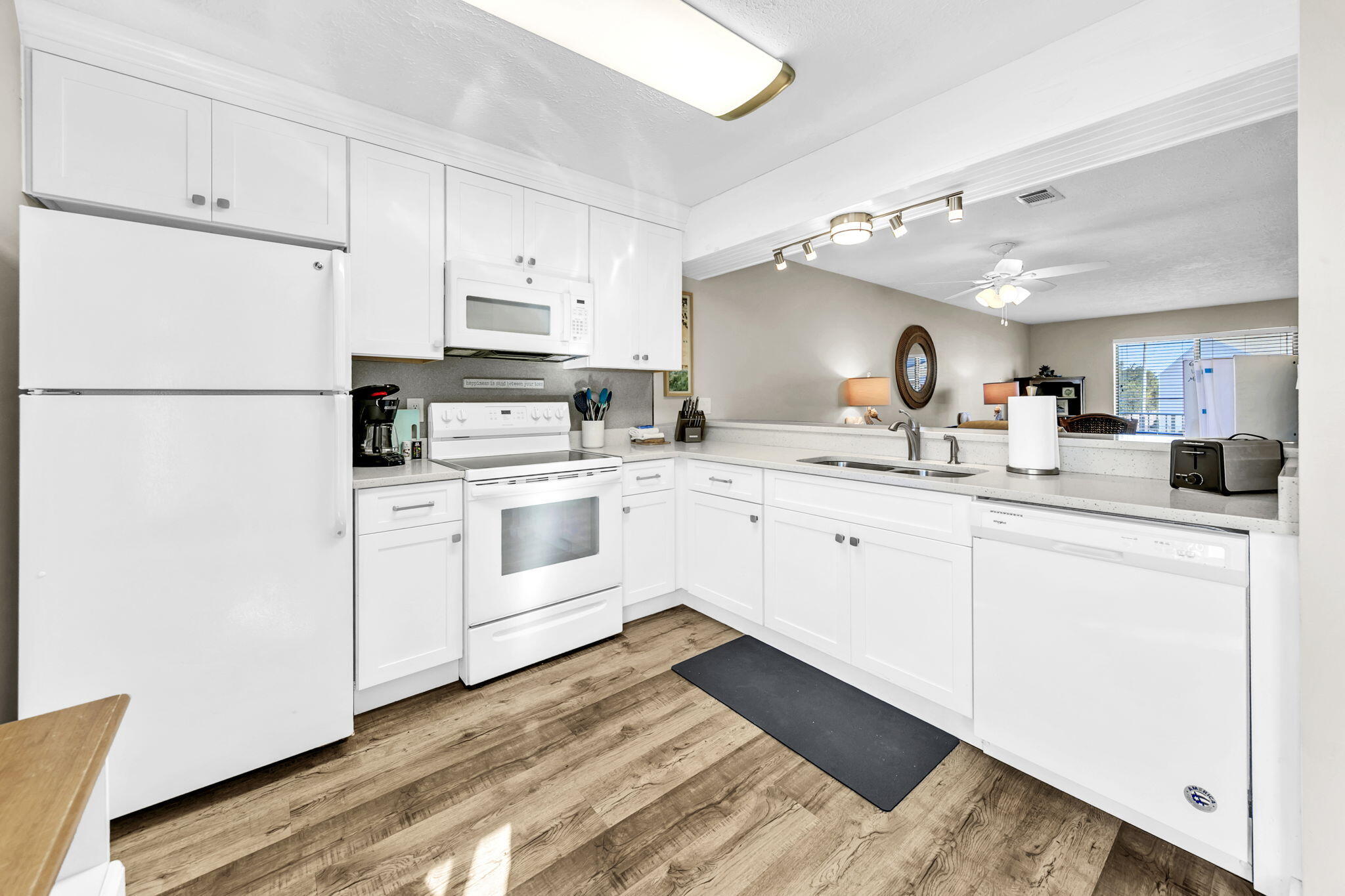 60 Sandprints Drive, Unit C12 Miramar Beach, FL 32550 - Photo 17 of 53 a kitchen with white cabinets sink and white appliances