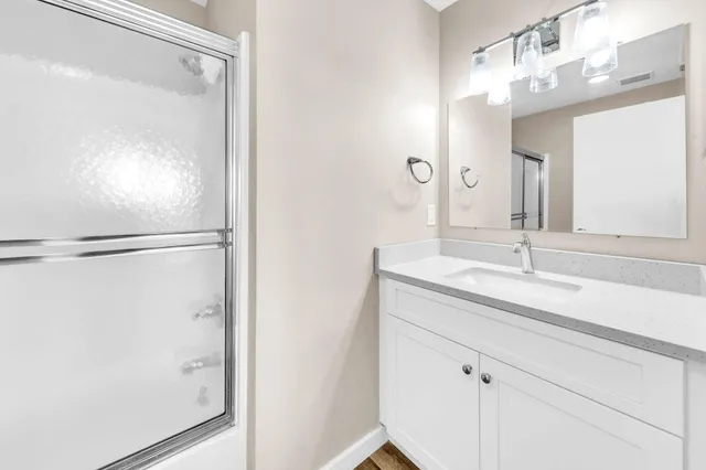 a bathroom with a glass shower door