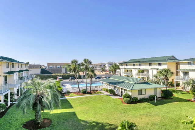 a view of a house with a backyard and sitting area