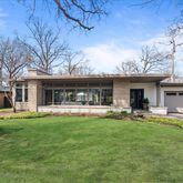 a front view of a house with swimming pool having outdoor seating