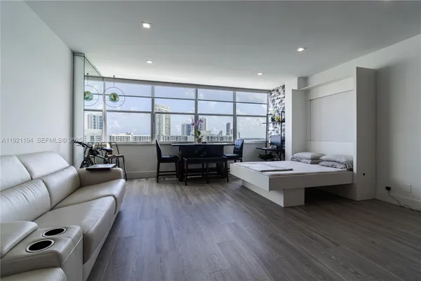a living room with furniture and wooden floor