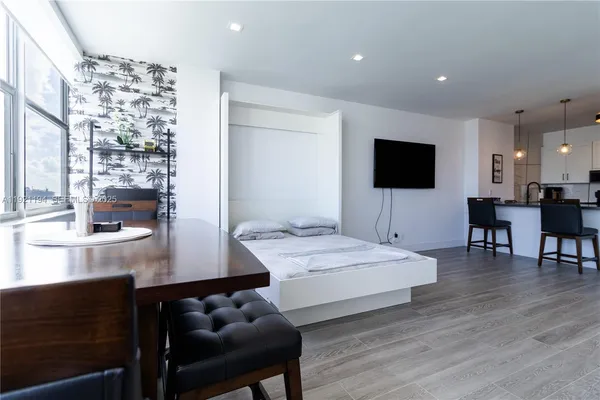 a bedroom with furniture and a flat screen tv