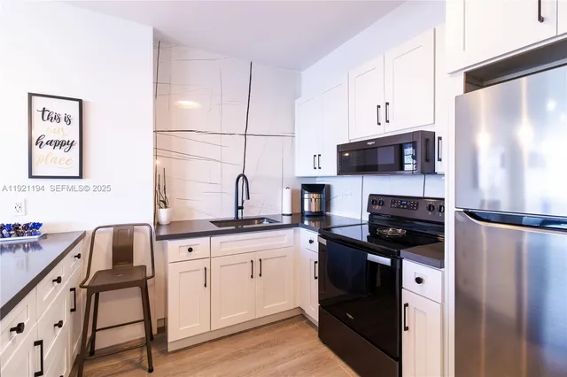 a kitchen with a refrigerator stove and sink