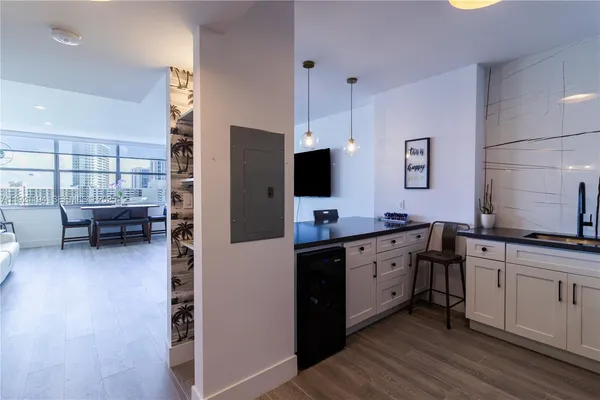a kitchen with appliances a sink and cabinets
