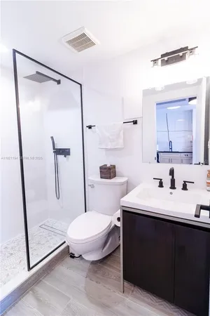 a bathroom with a sink toilet and shower