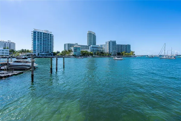 a view of a city with tall buildings and a bench
