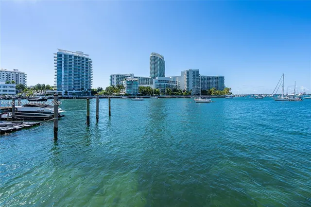 a view of a city with tall buildings and a bench