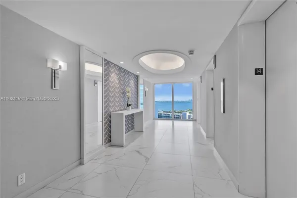 a bathroom with a tub and mirror