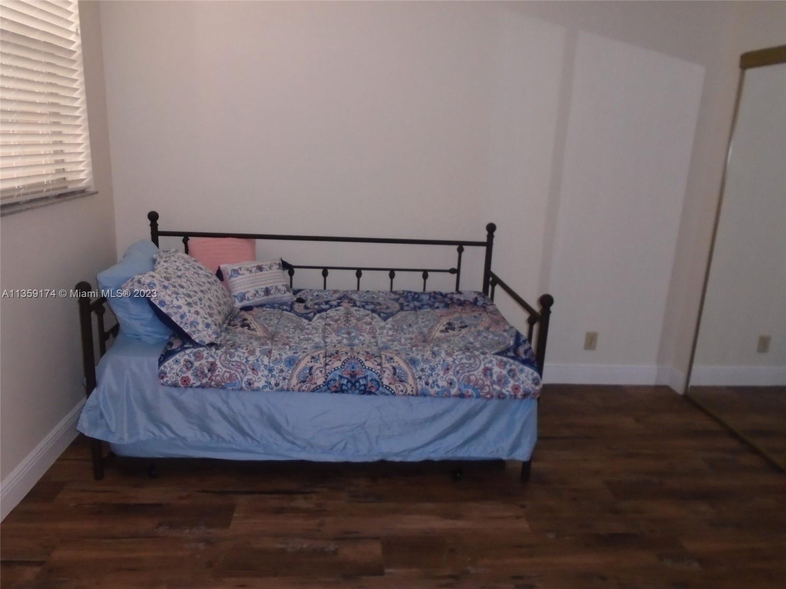 Sabal Palm of Pine Davie, FL 33324 - Photo 14 of 30 a bed sitting in a bedroom next to a window