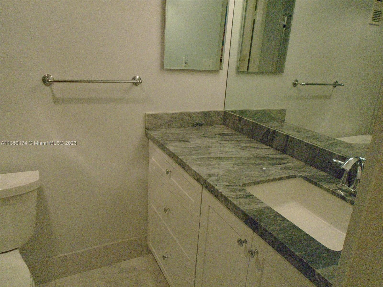 Sabal Palm of Pine Davie, FL 33324 - Photo 19 of 30 a bathroom with a granite countertop sink and a mirror