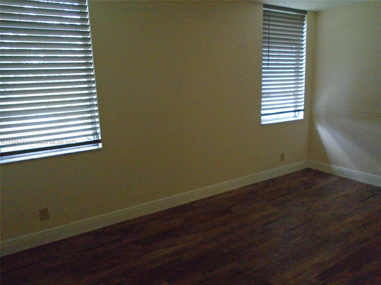 Sabal Palm of Pine Davie, FL 33324 - Photo 21 of 30 a view of a room that has wooden floor and a window