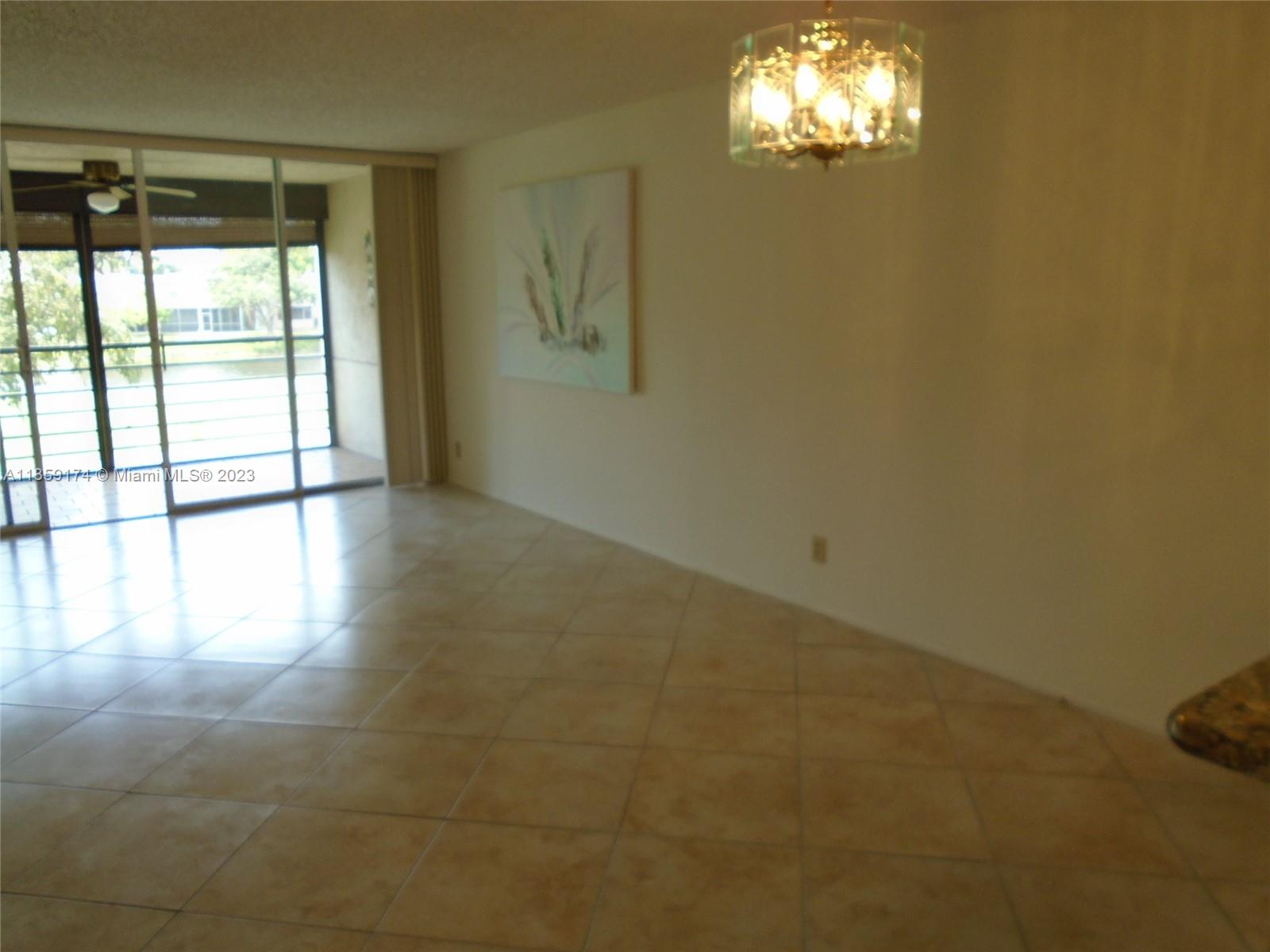 Sabal Palm of Pine Davie, FL 33324 - Photo 5 of 30 a view of empty room with wooden floor and fan