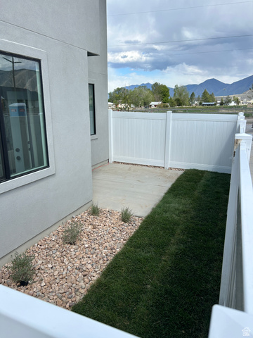 2011 West 1150 South, Unit 1042 Payson, UT 84651 - Photo 5 of 39 Photos are of model home.Exterior side yard featuring a concrete pathway, a gravel bed with plantings, and a manicured lawn