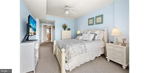 a bedroom with a bed and a lamp