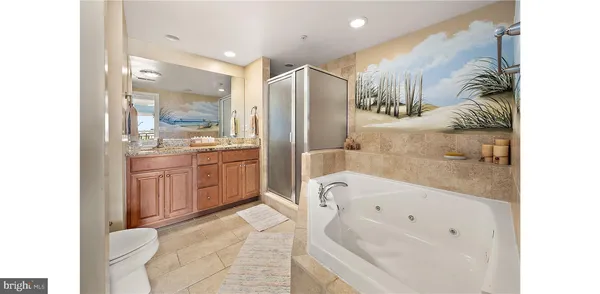 a bathroom with a bathtub sink and mirror