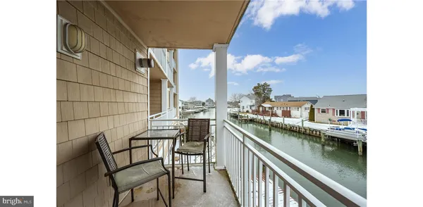 a view of a chairs and table in a balcony