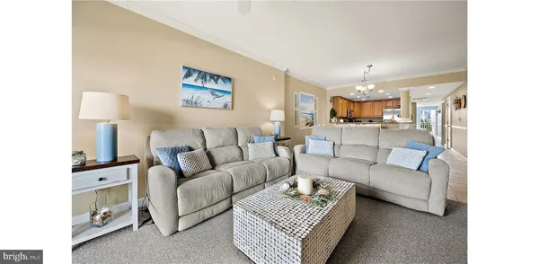 a living room with furniture a lamp and a chandelier
