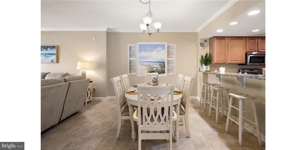 a view of a dining room with furniture and a chandelier