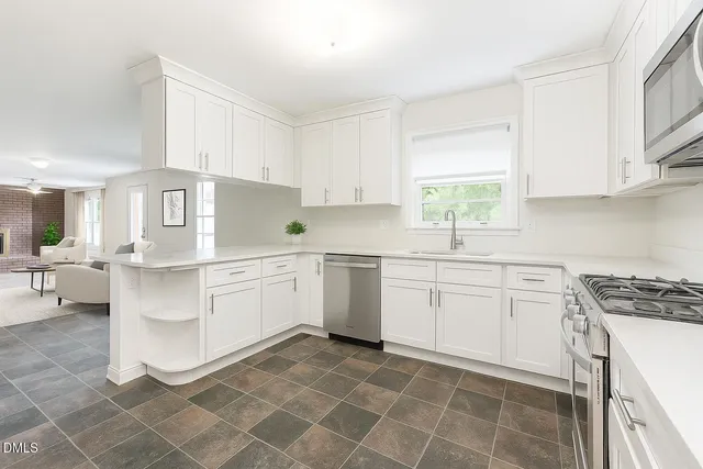 a kitchen with a white cabinets and white appliances