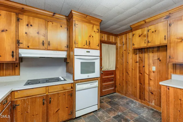 a kitchen with stainless steel appliances granite countertop a refrigerator and a stove